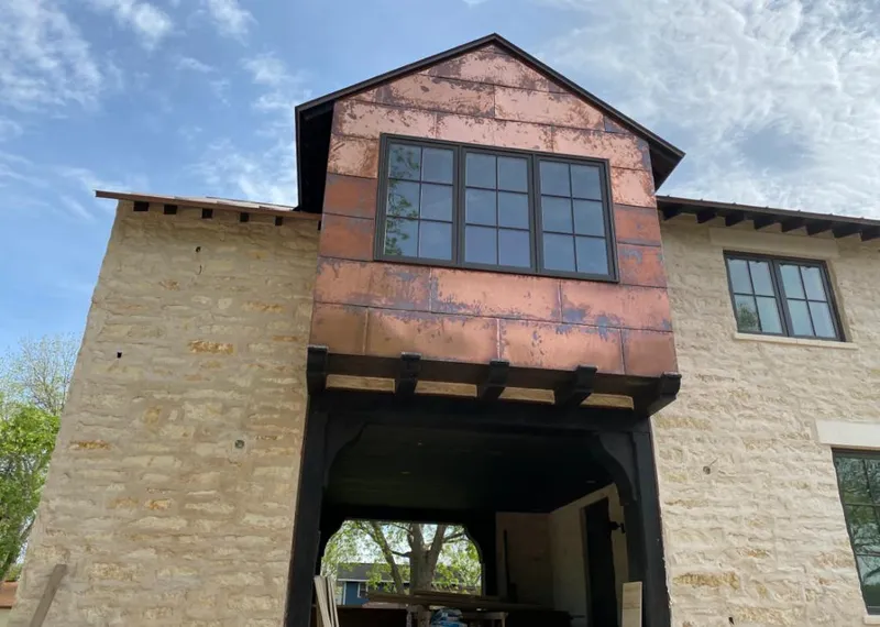 Copper metal panel facade on a stone building for Skylight Installation in Stony Point