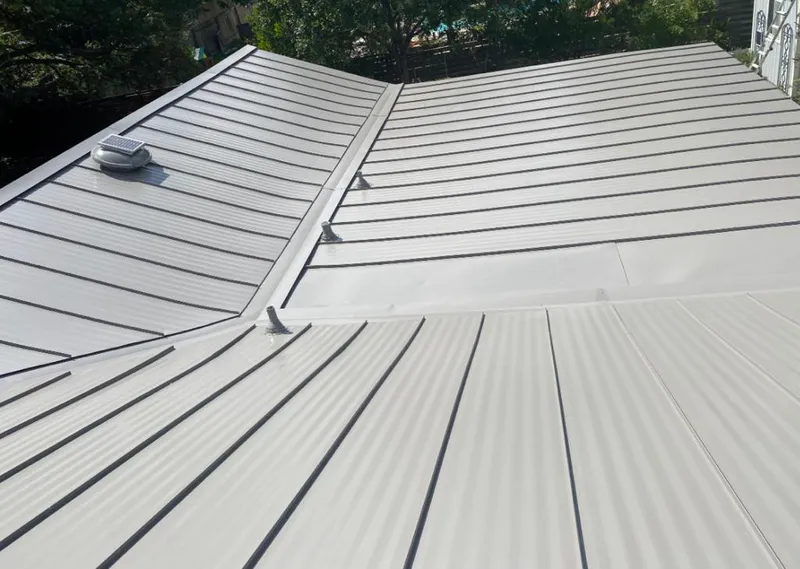 Solar attic fan installed on a metal roof for Roof Ventilation in Stony Point